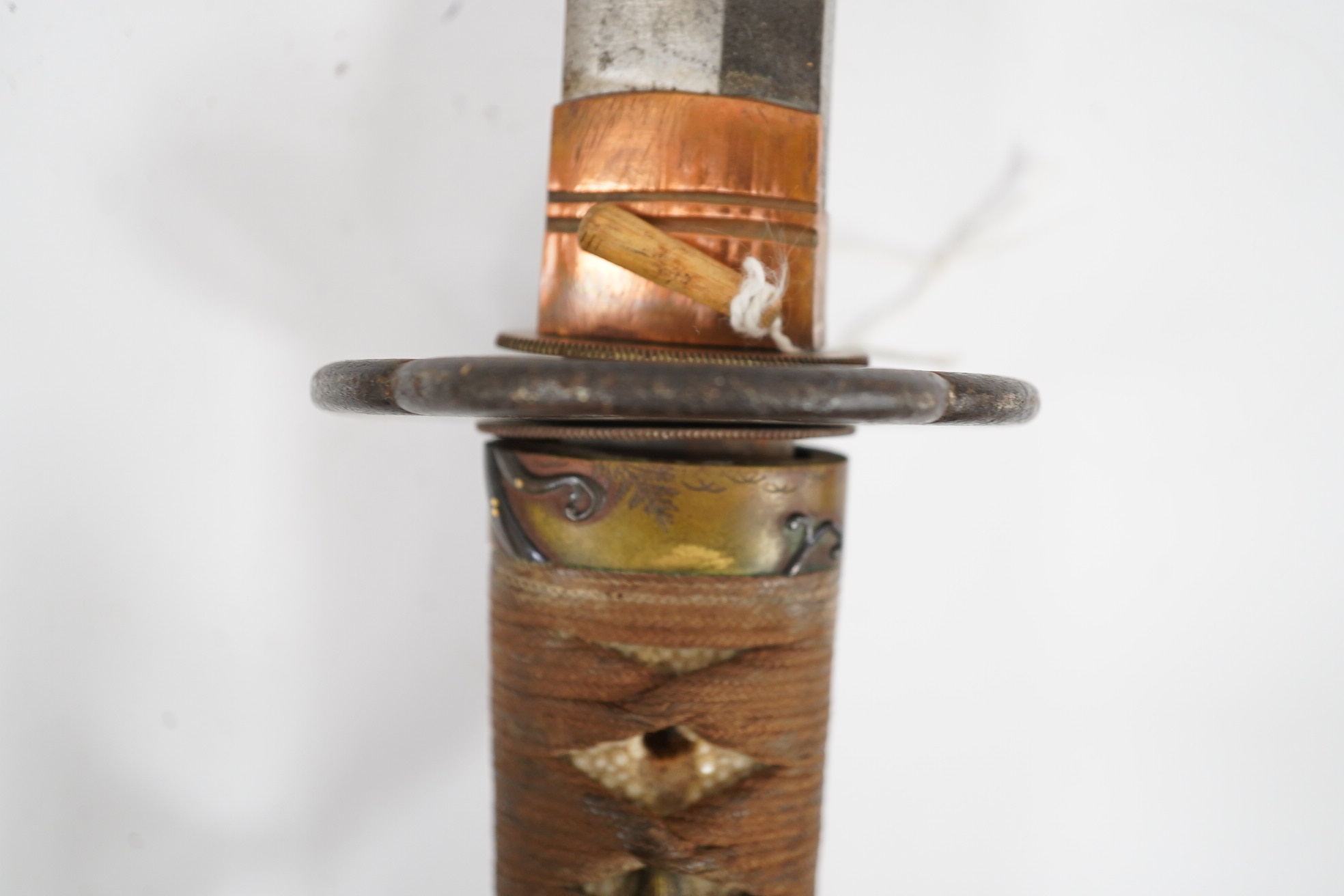 A 19th century Japanese sword wakizashi, blade 39.9cms, signed, iron Sukashi Tsuba of moko form, tape bound same tsuka with brass mounts, in its black lacquered saya. Condition - fair